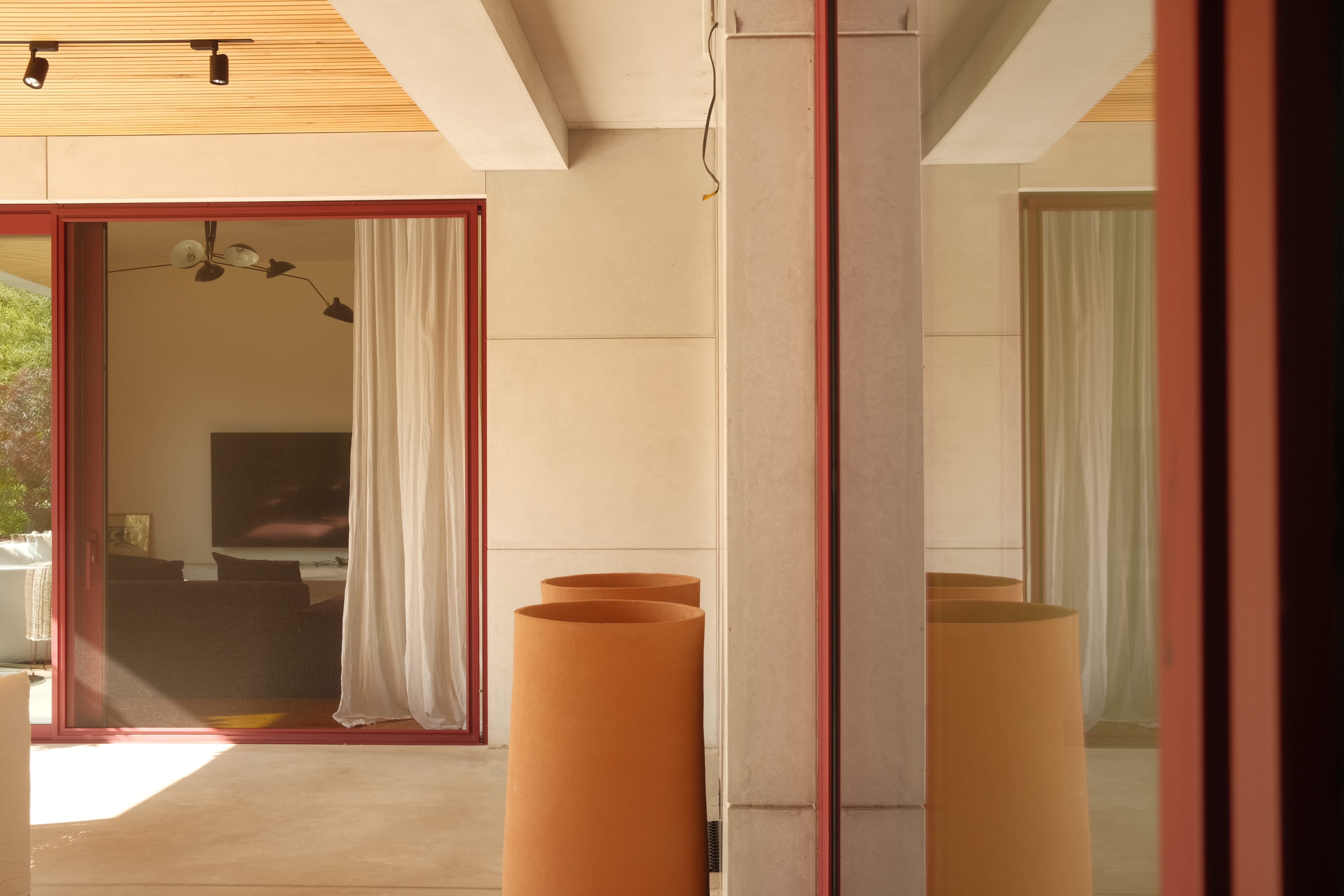 Terracotta-toned architectural exterior with reflective glass