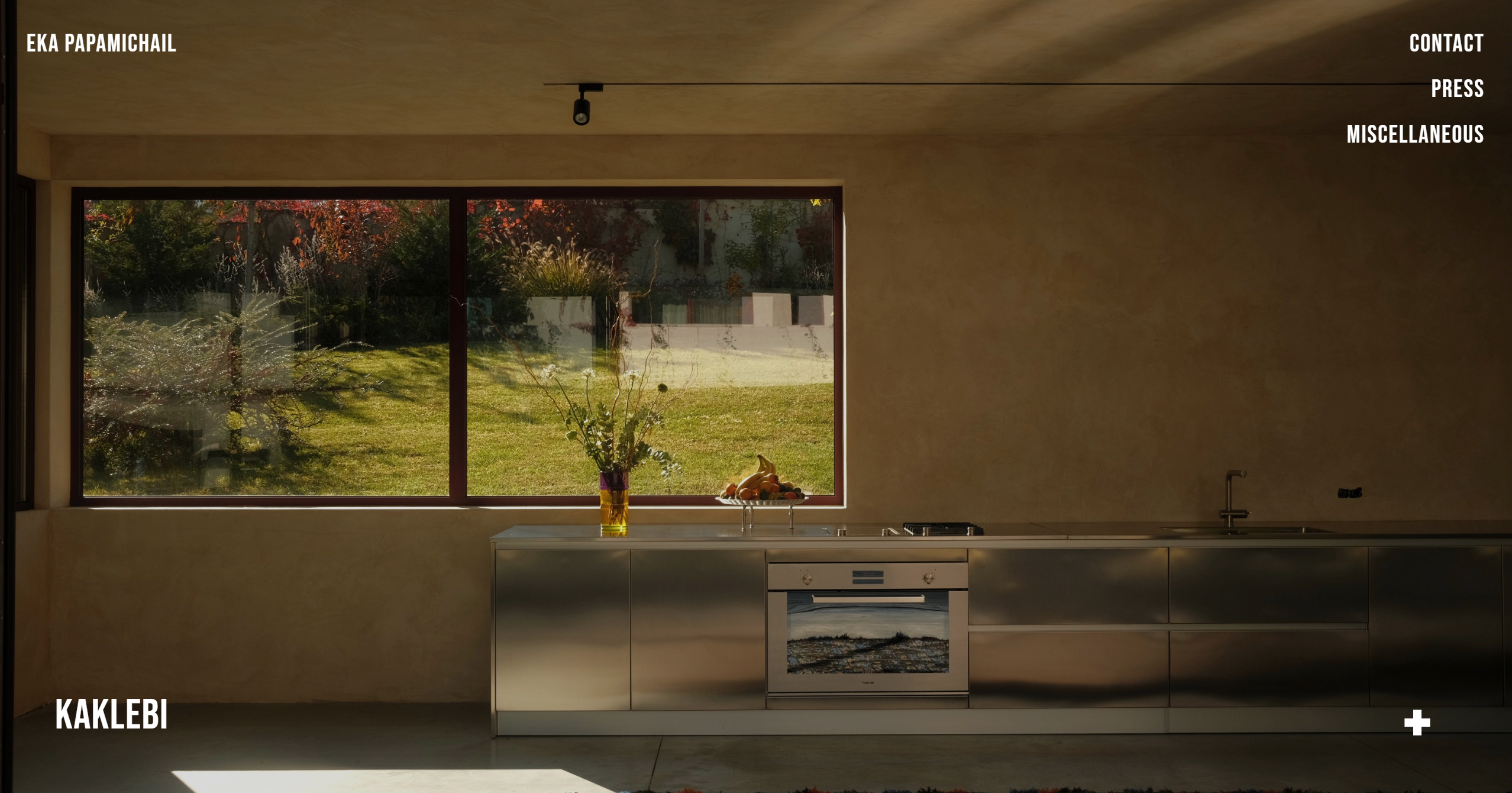 Desktop landing page with full-width kitchen photography and minimal navigation